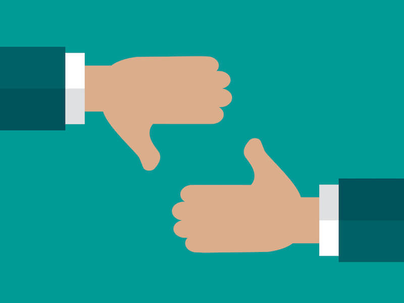 Hand with thumb up and down on blue background. Yes and no, pros and cons, like and dislike, negative and positive symbol.