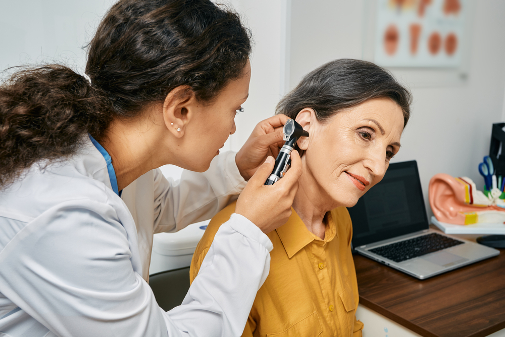 female patient and hearing specialist at clinic.